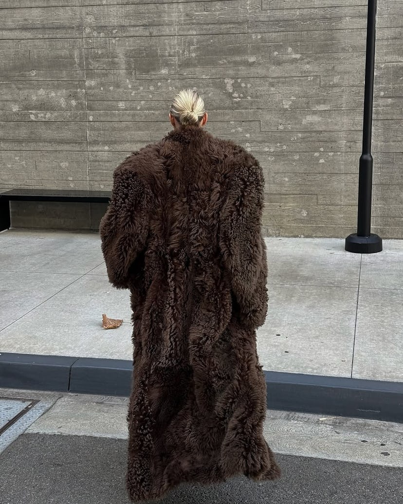 Elsa Hosk wears striped pajamas, a bra, and a fur coat.