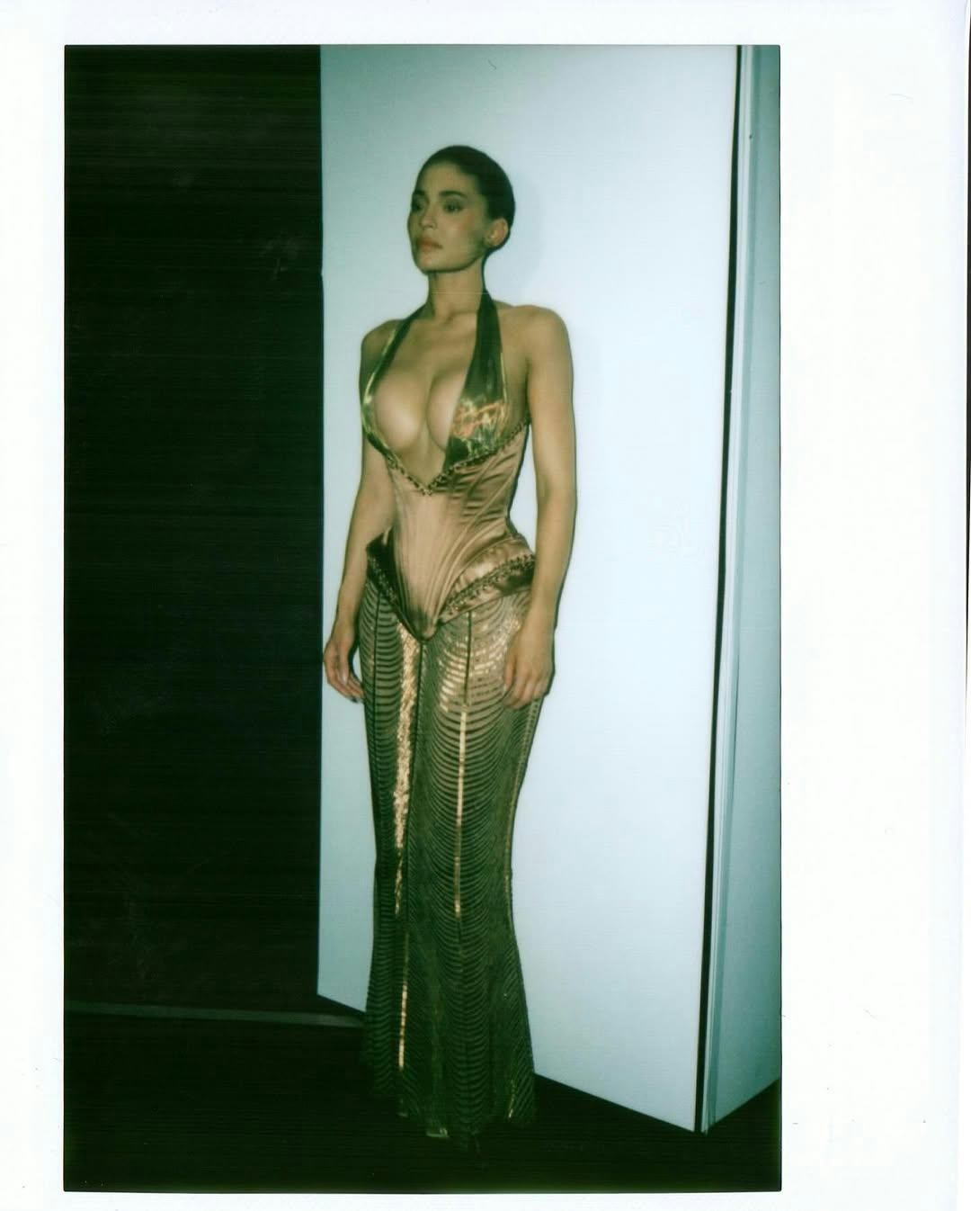 Kylie Jenner wears a plunging bronze Jean Paul Gaultier gown.