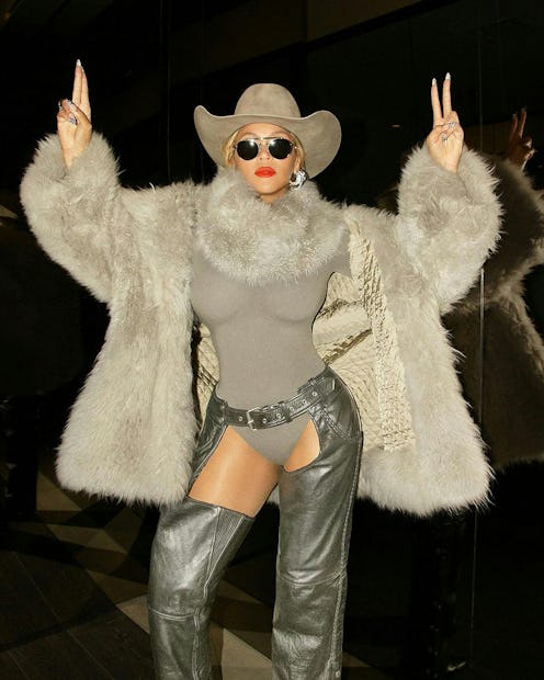 Beyoncé wears a gray bodysuit, chaps, and a furry coat.
