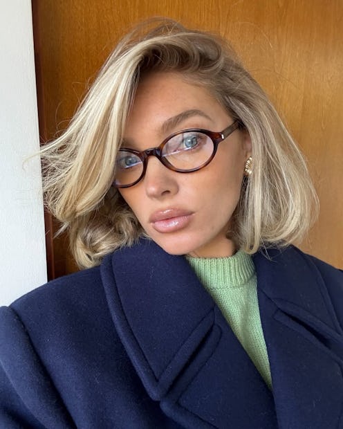 Elsa Hosk wears a coat and glasses.