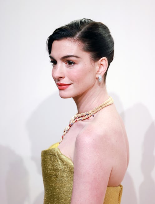 Anne Hathaway wore a 'Princess Diaries'-coded gold ball gown to the opening ceremony of Bvlgari Infi...
