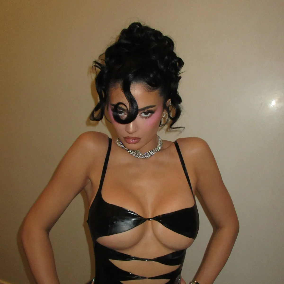 kylie jenner cut out dress Kylie Jenner shows skin in low-cut mini dress with multiple cutouts