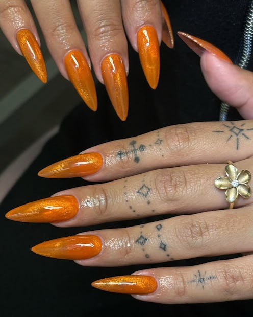 Orange cat-eye nail designs perfect for honoring Taylor Swift's 'Showgirl' era.