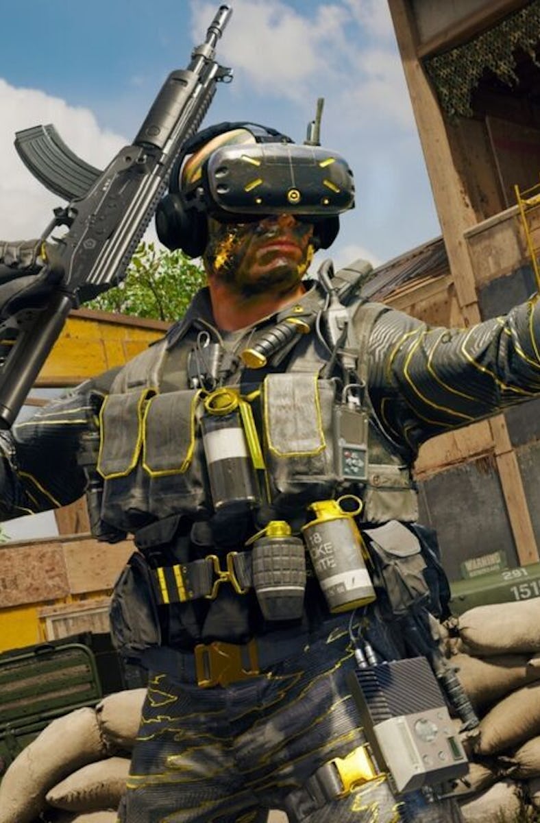 A soldier with gear on his face pointing.