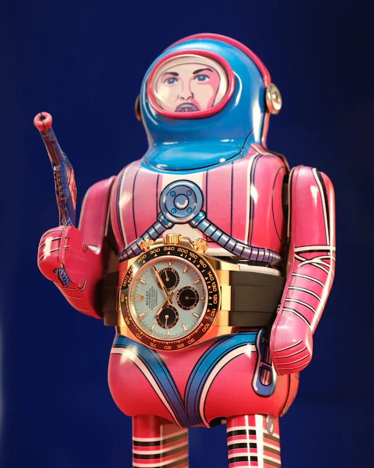 Rolex watch on a tin toy man