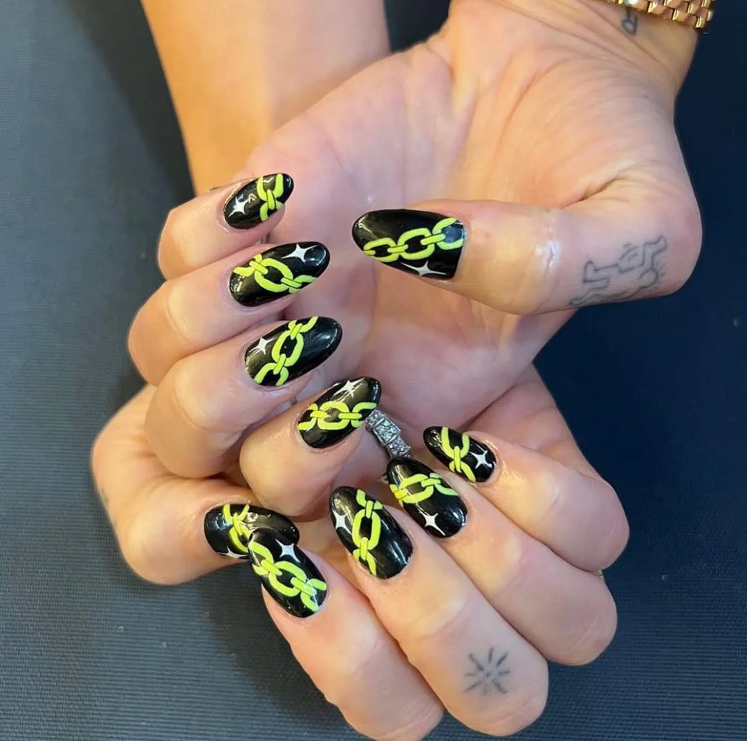Dua Lipa with neon chain link nails
