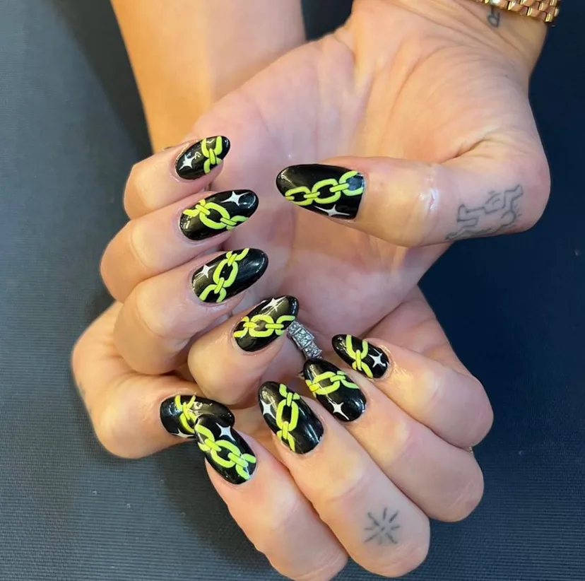 Dua Lipa with neon chain link nails