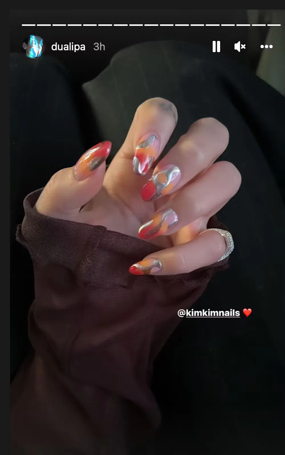 Dua Lipa chrome accented nails