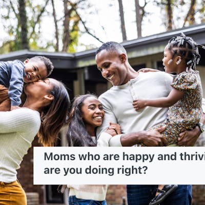 A happy family stands in front of their house.