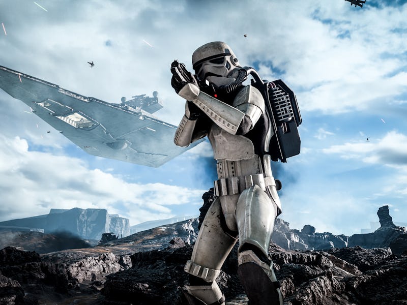 A stormtrooper aiming his weapon with a Star Destroyer flying in the sky behind them.
