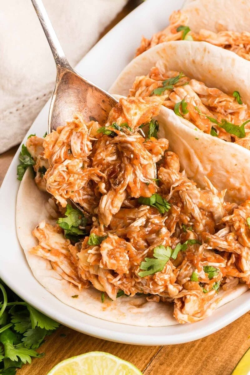 shredded salsa chicken in the crockpot, in a story about cheap recipes to feed a crowd