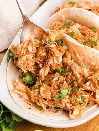 shredded salsa chicken in the crockpot, in a story about cheap recipes to feed a crowd