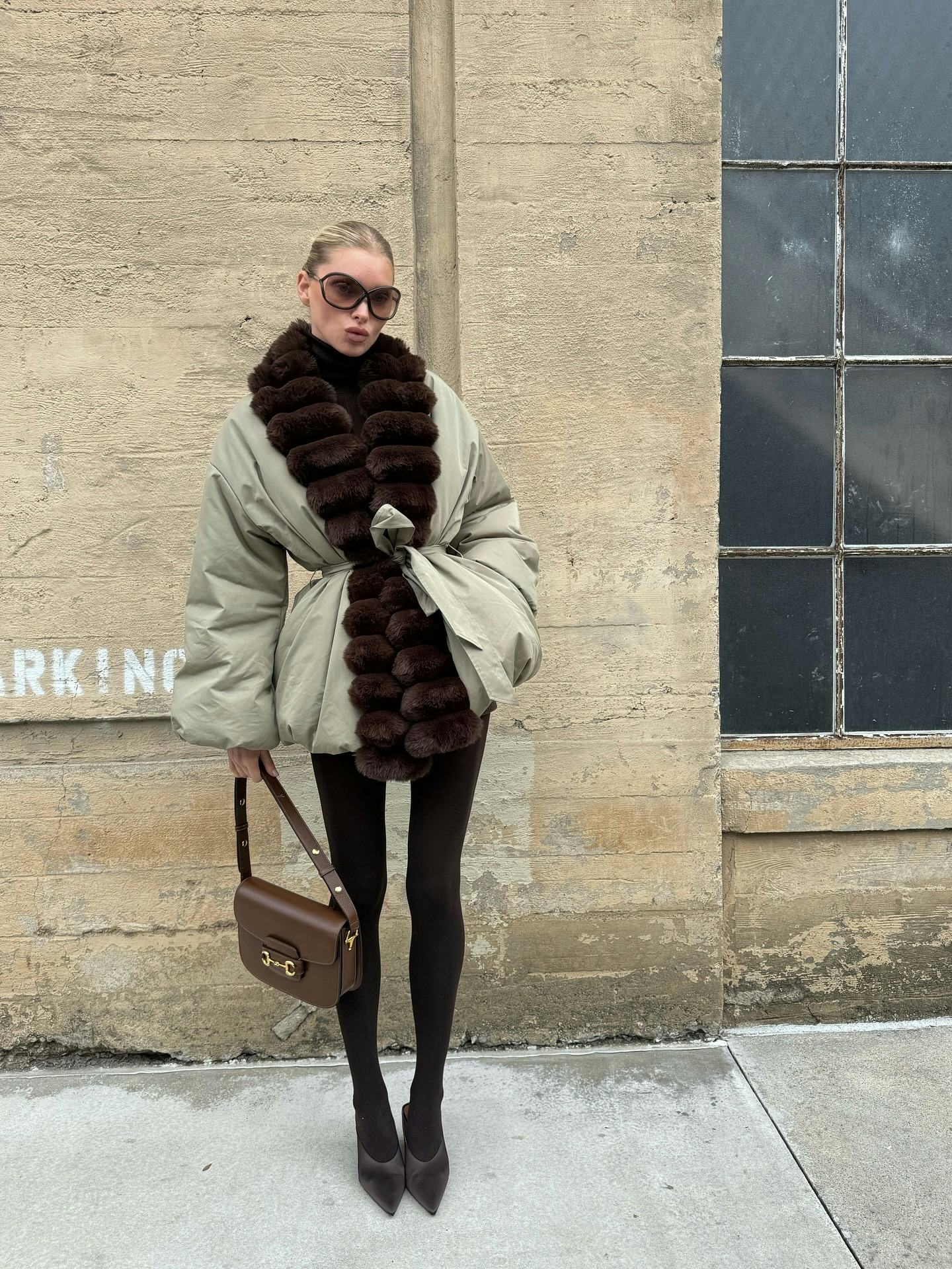 Elsa Hosk wears a puffer jacket and tights. 