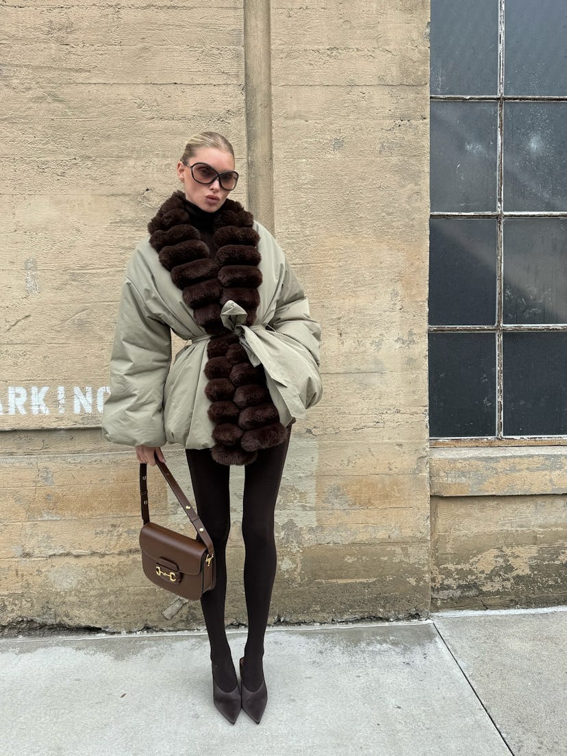 Elsa Hosk wears a puffer jacket and tights.