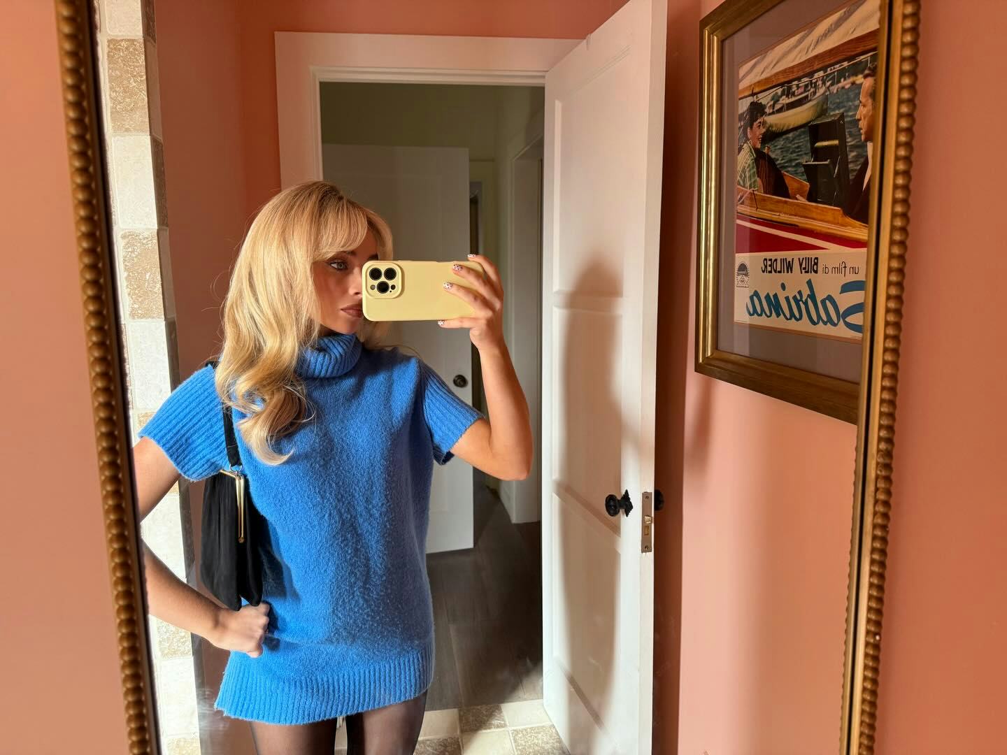 Sabrina Carpenter wears a blue sweater dress. 
