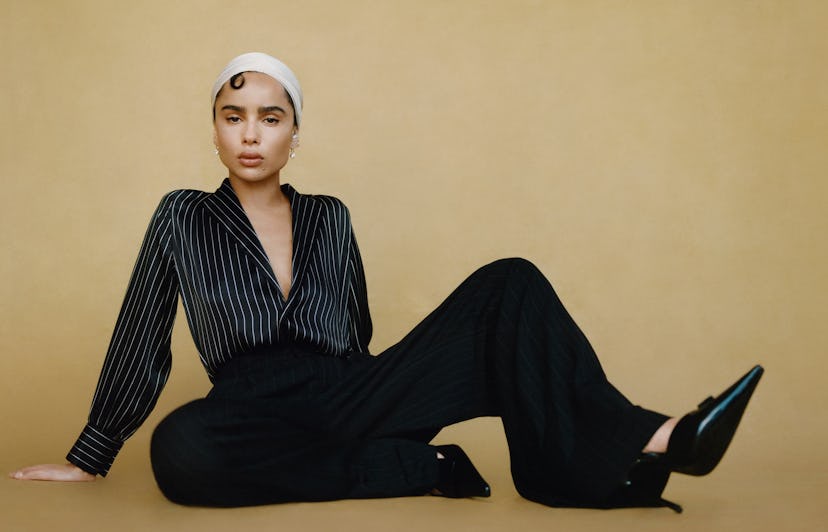 Zoë Kravitz wearing a striped black shirt and silk pants