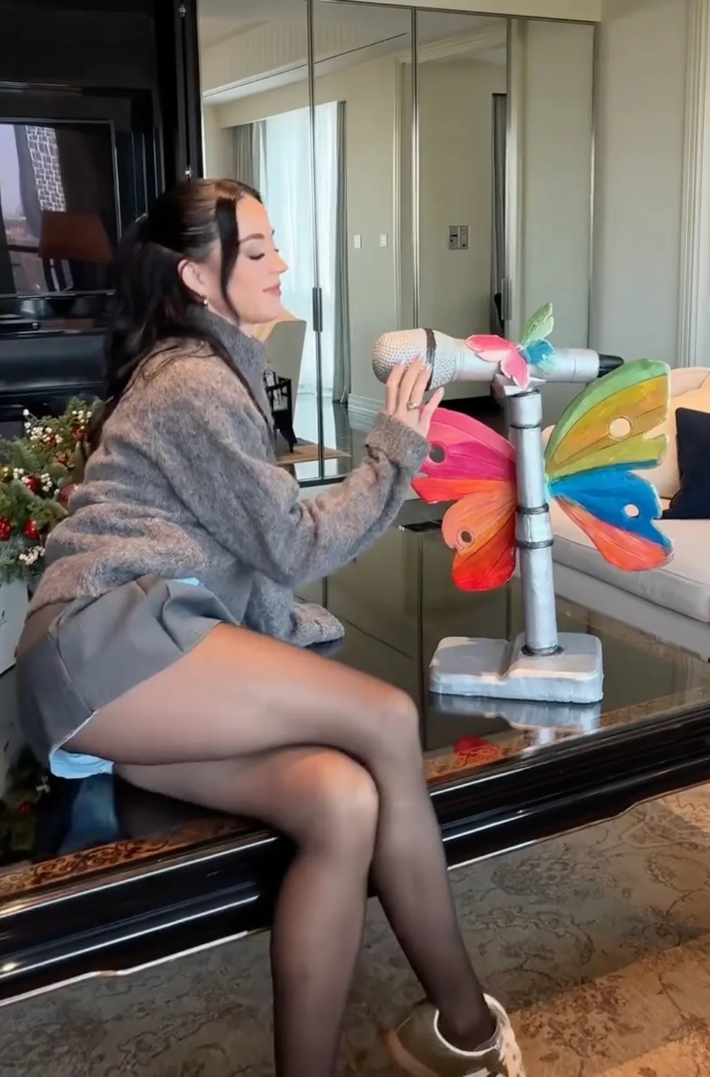 Katy Perry aced holiday dressing in a cozy turtleneck and miniskirt.