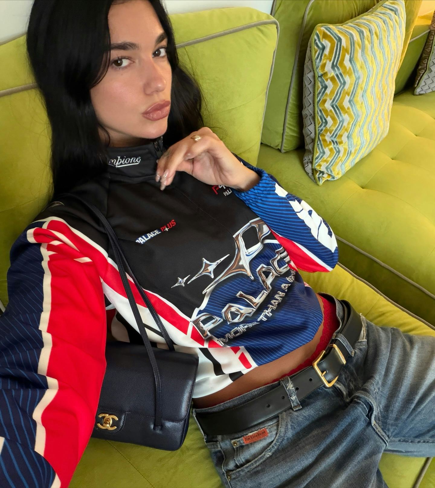 Dua Lipa wears a moto jacket and jeans.