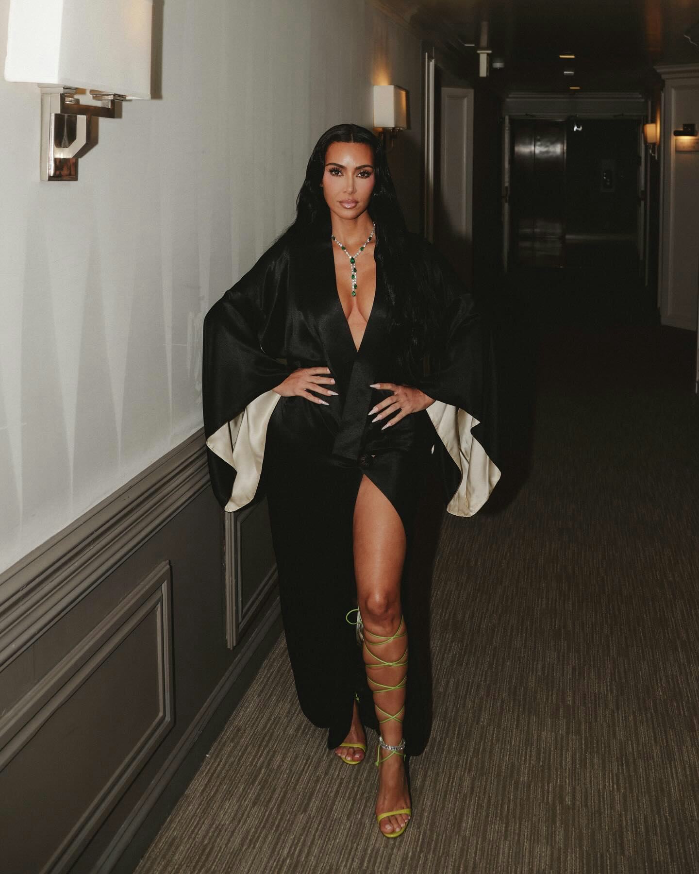 Kim Kardashian wears a black robe. 