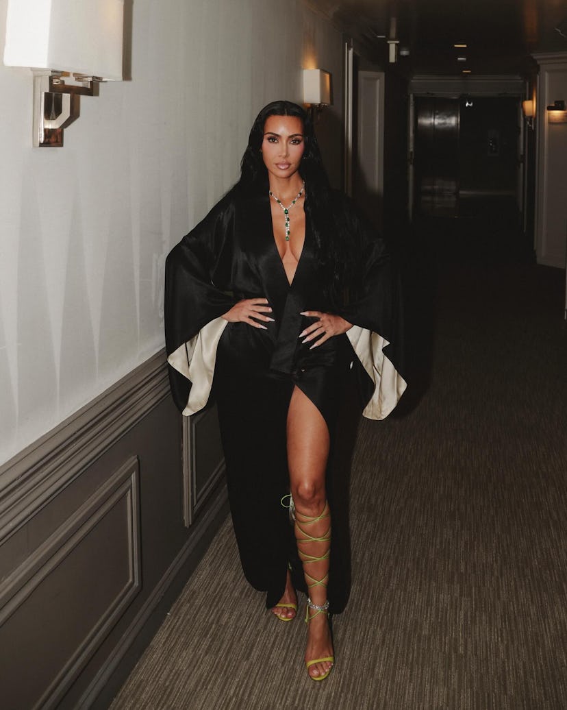 Kim Kardashian wears a black robe.