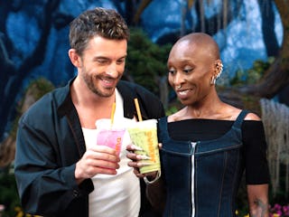 Jonathan Bailey and Cynthia Erivo cheersing with Dunkin's Wicked Pink Refresher and Green Matcha.