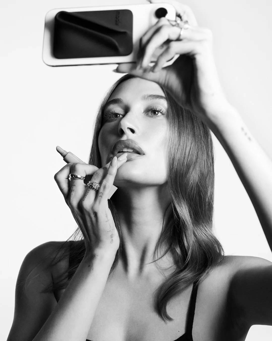Hailey Bieber holding Rhode's Snap-On Phone Case.