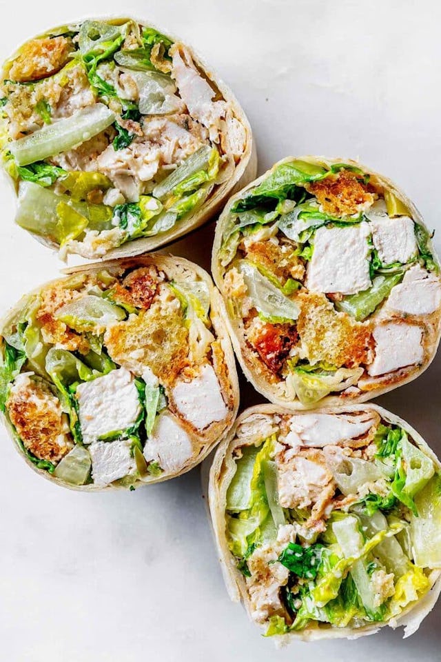 chicken caesar wrap cut in half, in a story about easy work lunch recipes
