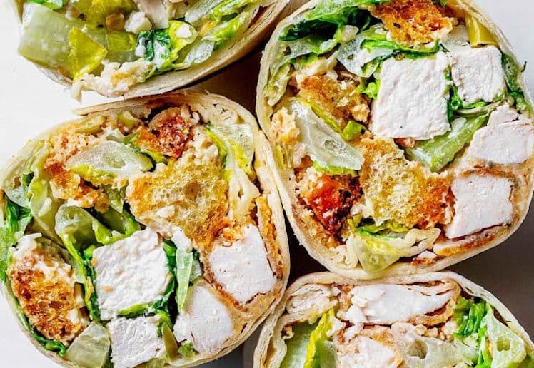 chicken caesar wrap cut in half, in a story about easy work lunch recipes