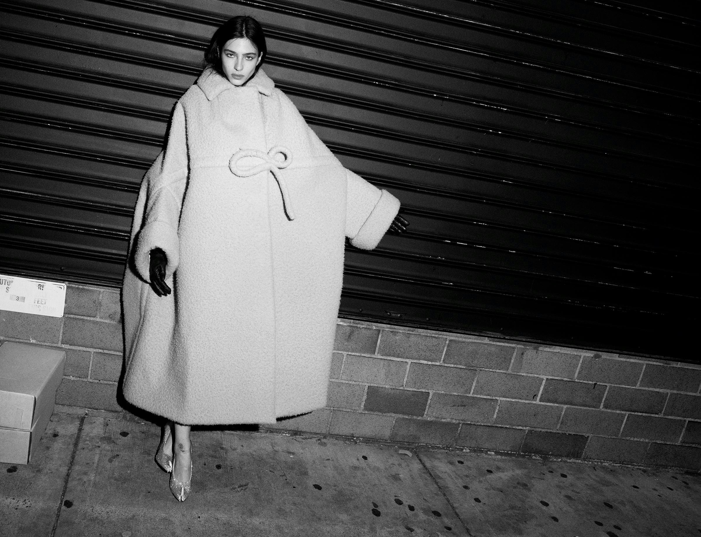 Loli Bahia wears a Maison Margiela Artisanal by John Galliano coat and shoes; stylist’s own gloves.