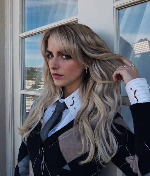 McKenna Grace holding her icy blonde-beige hair