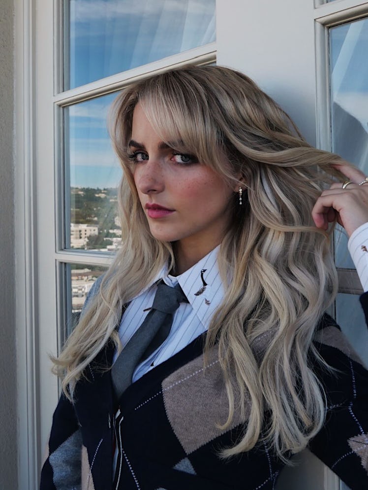 McKenna Grace holding her icy blonde-beige hair