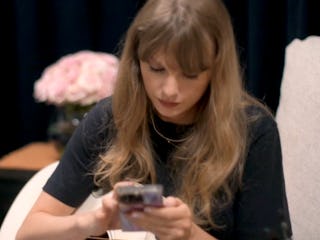 Taylor Swift is shown listening to Liz Moore's 'The God of the Woods' in her 'End of an Era' docuser...