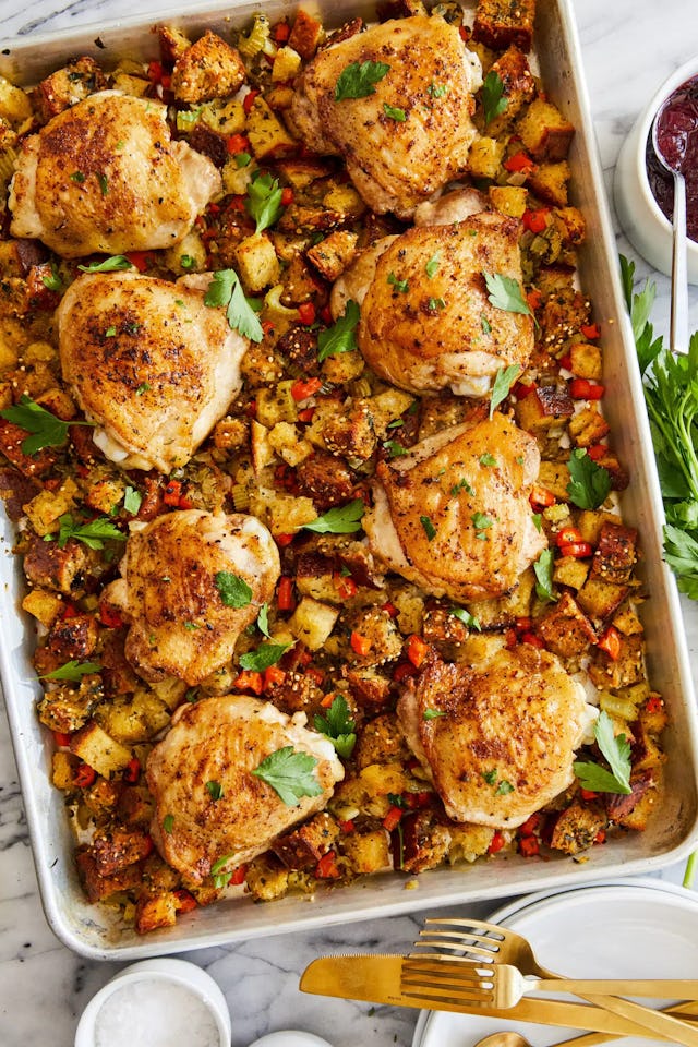 sheet pan with chicken thighs and stuffing, in a story about christmas recipes for a crowd