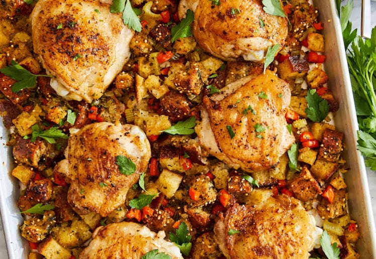 sheet pan with chicken thighs and stuffing, in a story about christmas recipes for a crowd