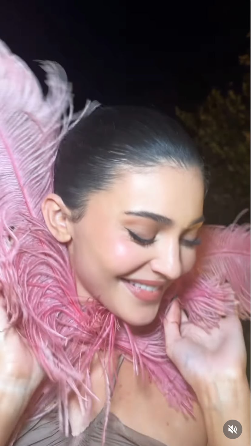 Kylie Jenner wears a pink cutout dress.