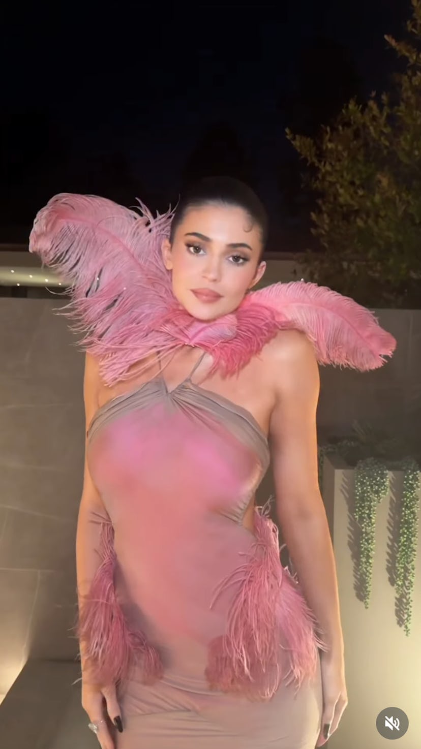 Kylie Jenner wears a pink cutout dress.