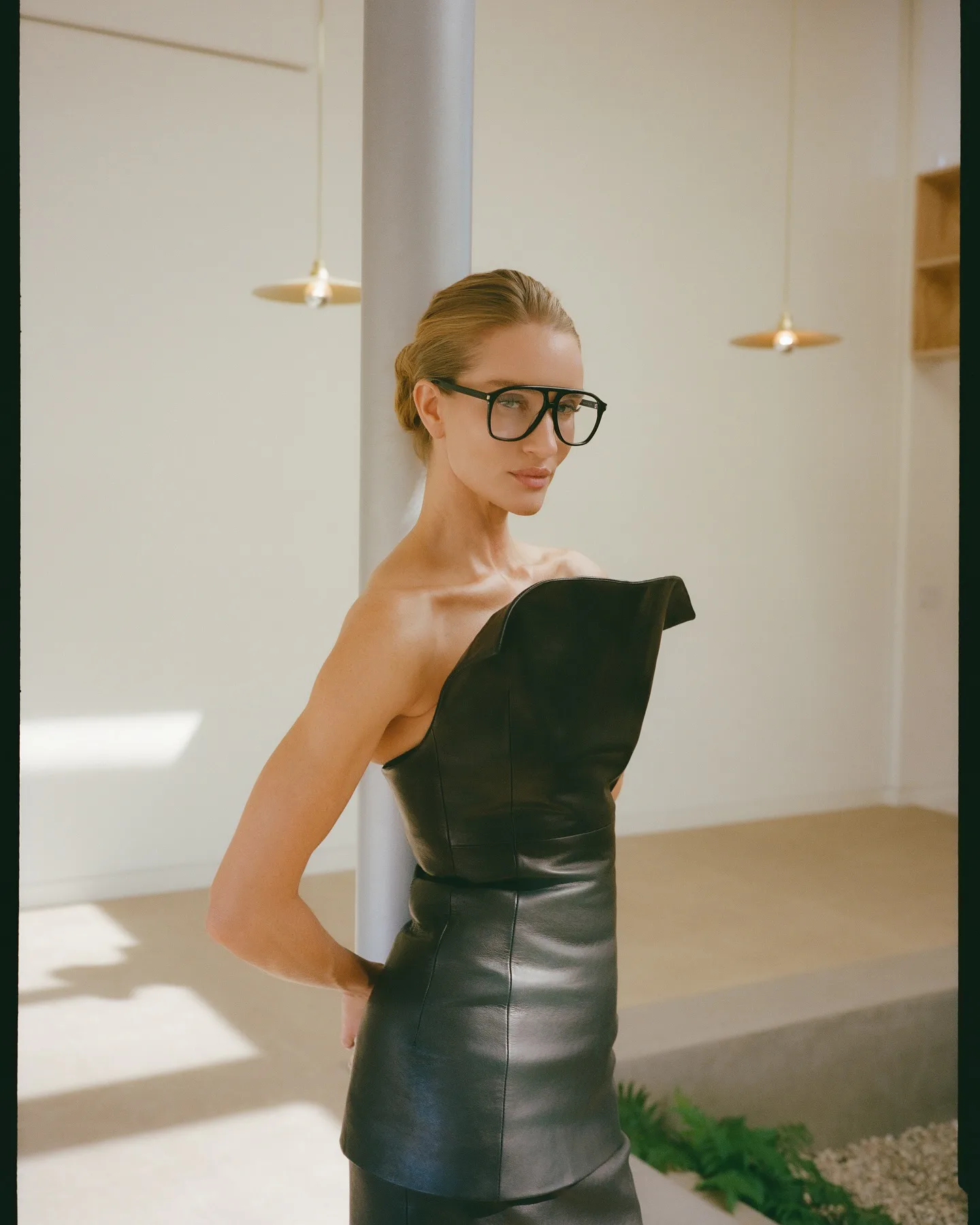 Rosie Huntington-Whiteley wears leather co-ords and eyeglasses. 