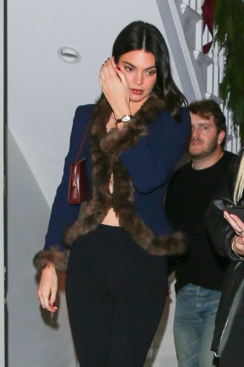 Hailey Bieber and Kendall Jenner wore '80's inspired looks with plunging necklines to a holiday part...