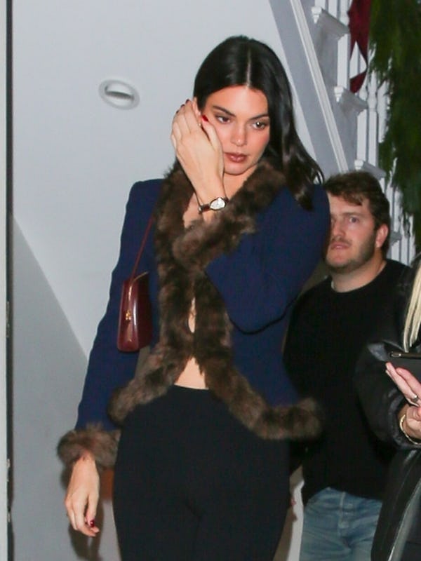 Hailey Bieber and Kendall Jenner wore '80's inspired looks with plunging necklines to a holiday part...