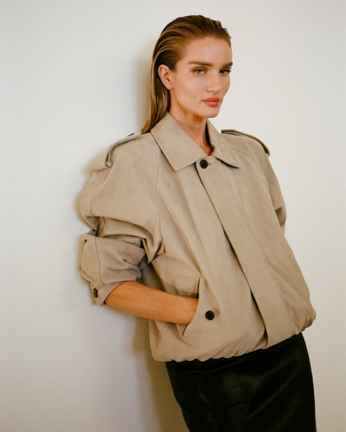 Rosie Huntington-Whiteley wears a trench coat and skirt.