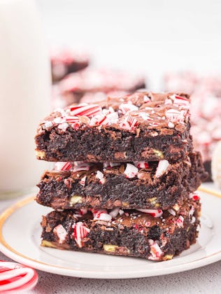 Candy cane brownies in a stack of three, in a story about easy christmas baking recipes