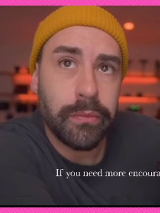 A man cries as he listens to elementary school kids giving him a pep talk.