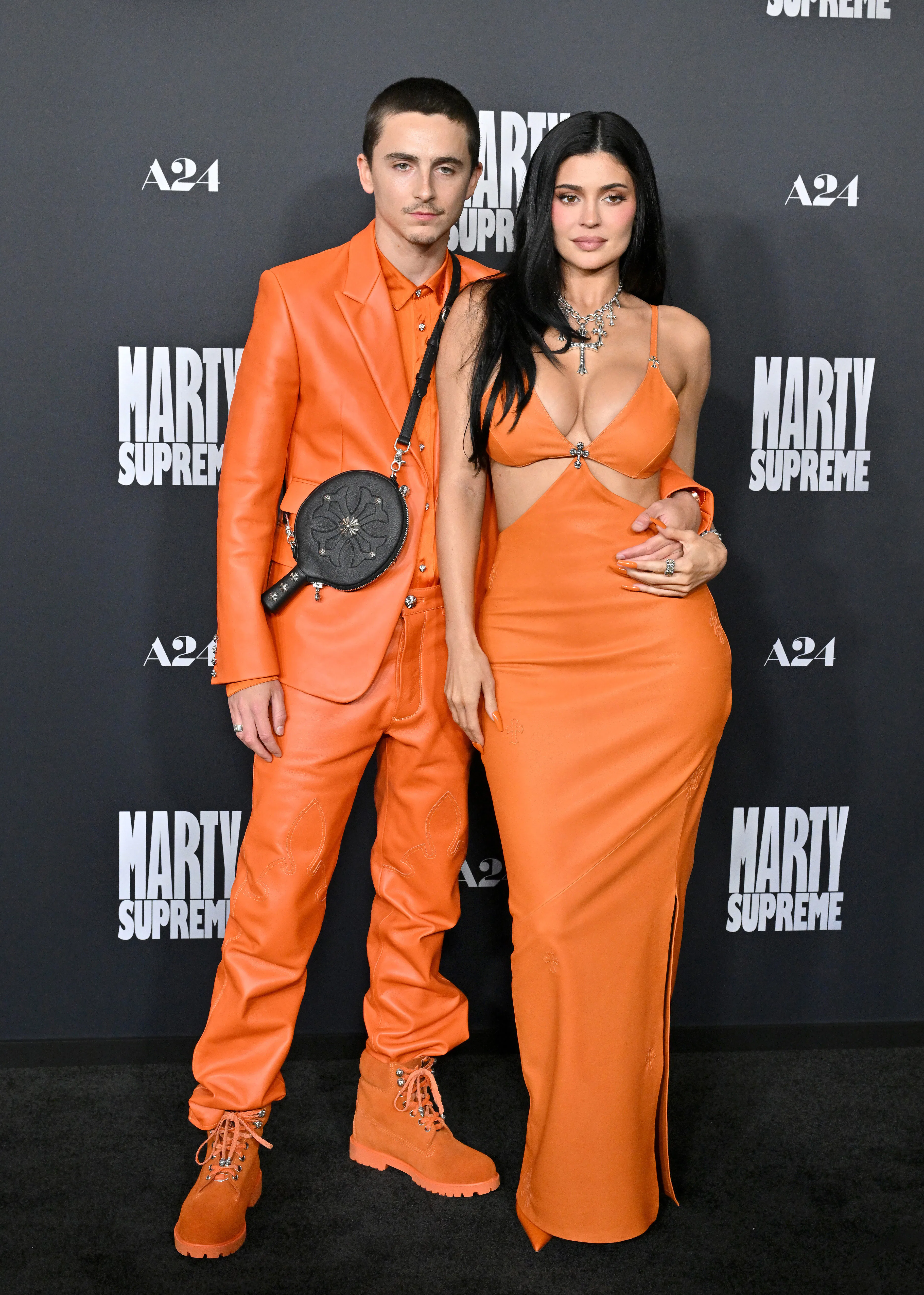 Timothée Chalamet & Kylie Jenner wearing matching orange outfits at the 'Marty Supreme' Los Angeles ...