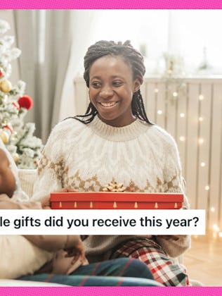 A woman smiles politely at a bad Christmas gift.
