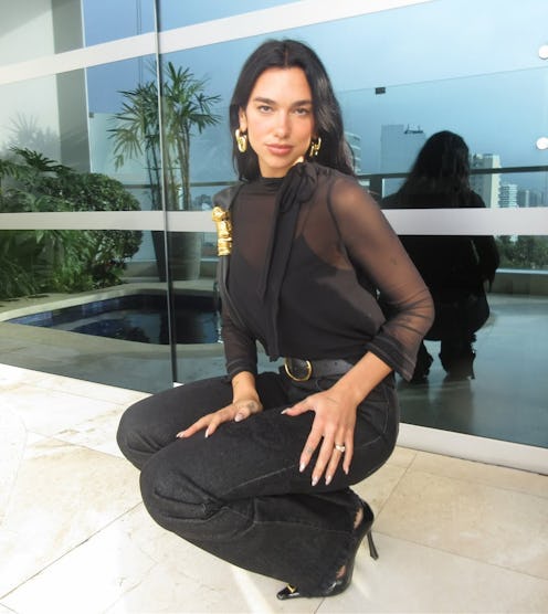 Dua Lipa wore a sheer slip dress and midriff-baring top on vacation in CDMX.