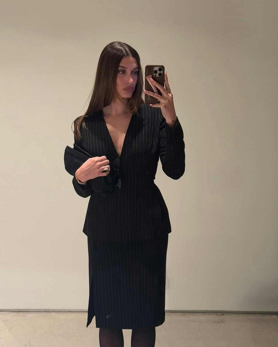 Hailey Bieber wears a skirtsuit.  