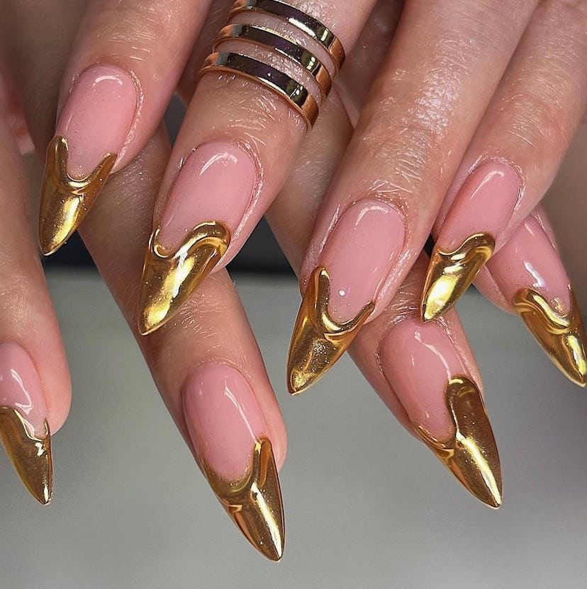 Stiletto French nails with gold chrome tips