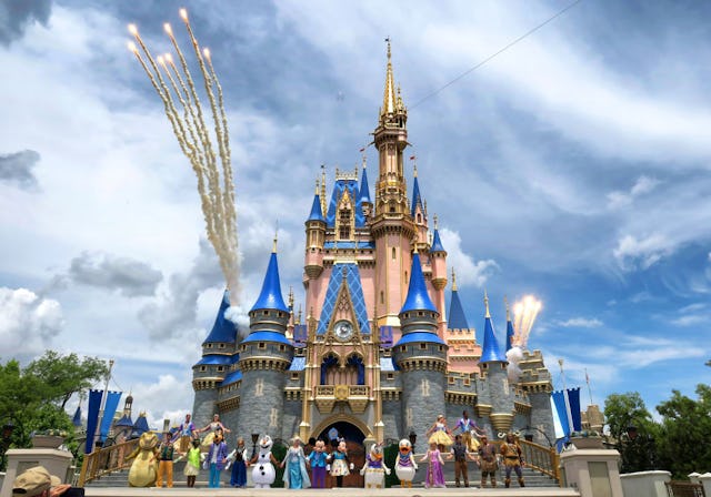 Daytime fireworks launch over Cinderella Castle during a performance of "Mickey's Magical Friendship...