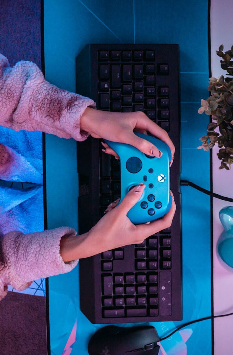 A player holds an Xbox controller