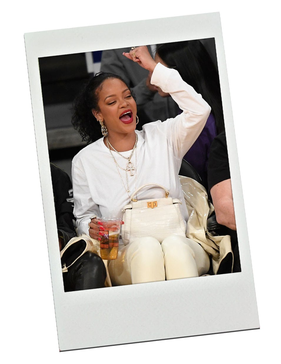 Rihanna wearing the Fendi Peekaboo bag at a basketball game.